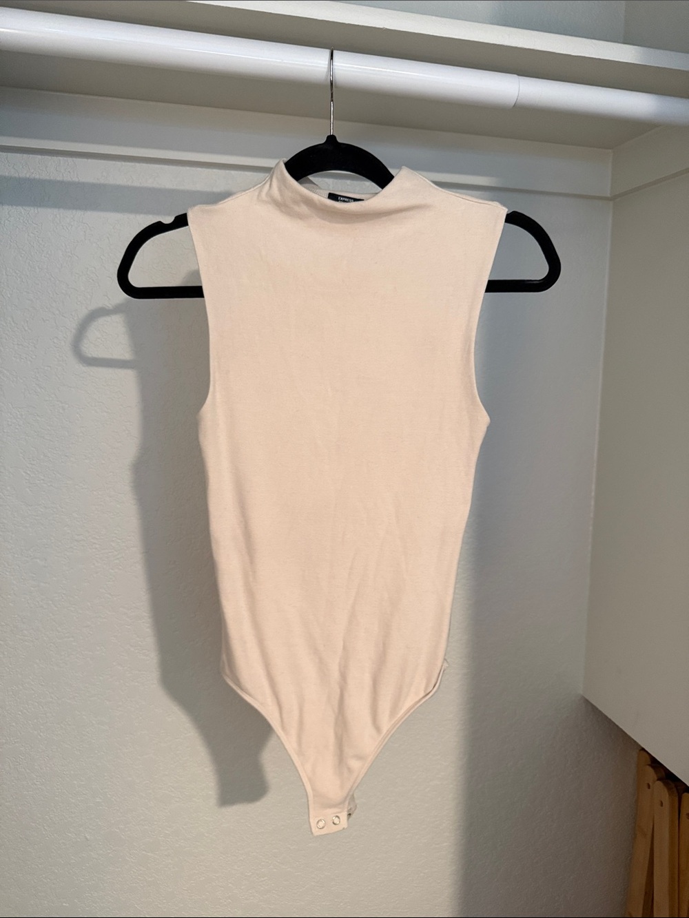 Express Cozy Body Contour Sleeveless Mock Neck Bodysuit in Light Beige